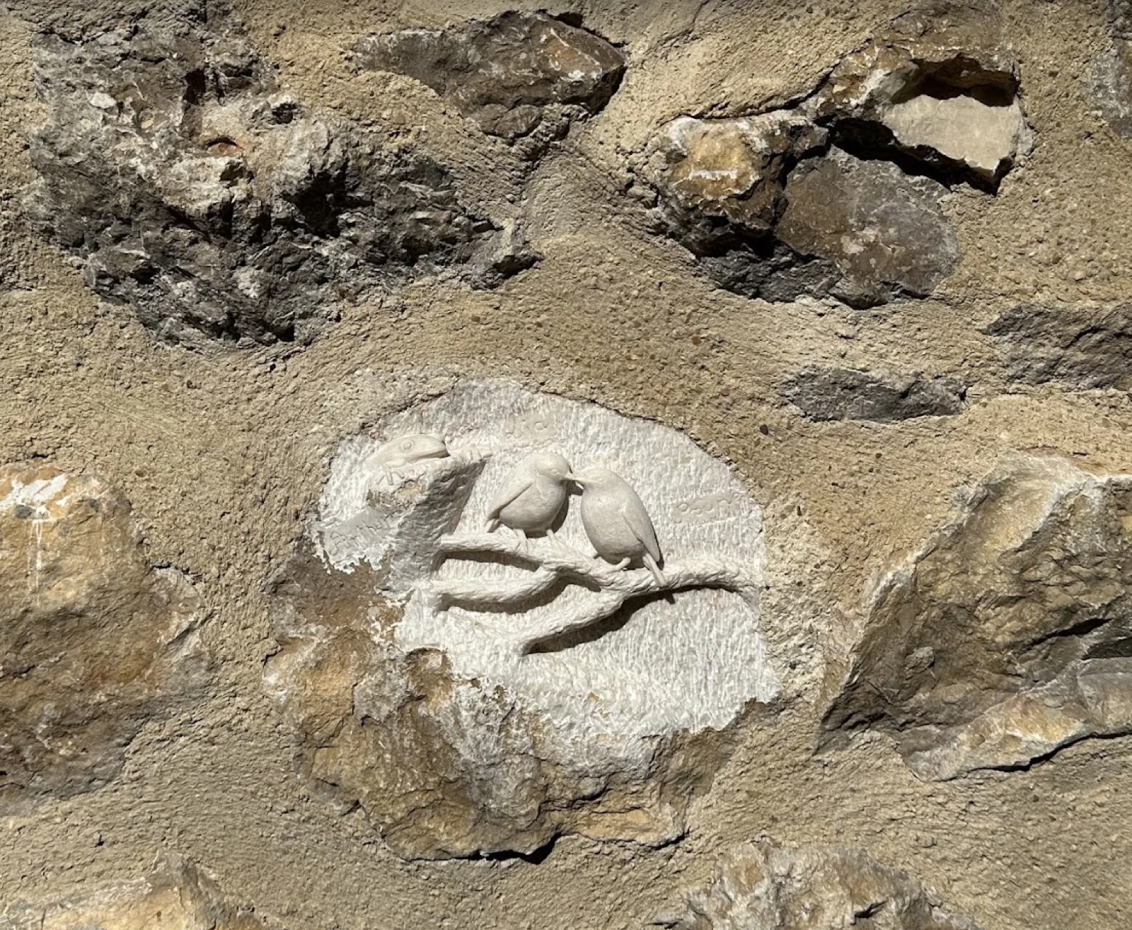 Trois oiseaux taillés dans la pierre d'une façade du village